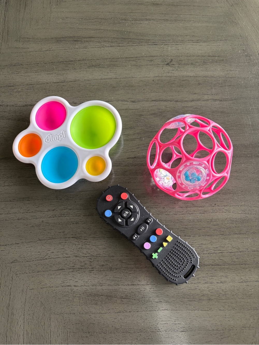 Baby toy bundle Dimpl Sensory Push Pop Toy, fake remote and rattle ball